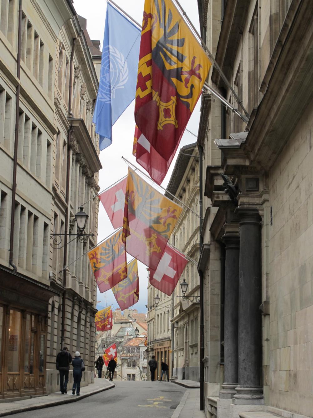 Walking a flag-lined street on a weekend trip in Geneva, Switzerland. Walking a flag-lined street on a weekend trip in Geneva, Switzerland.